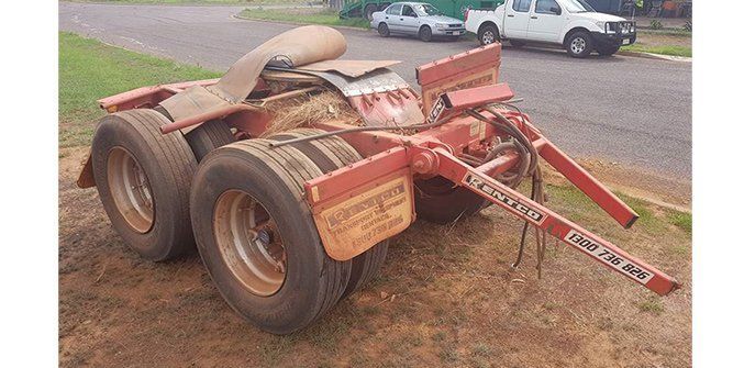 A Red Trailer is Parked on the Side of the Road Next to a White Truck — Roll Press NT In Tivendale, NT