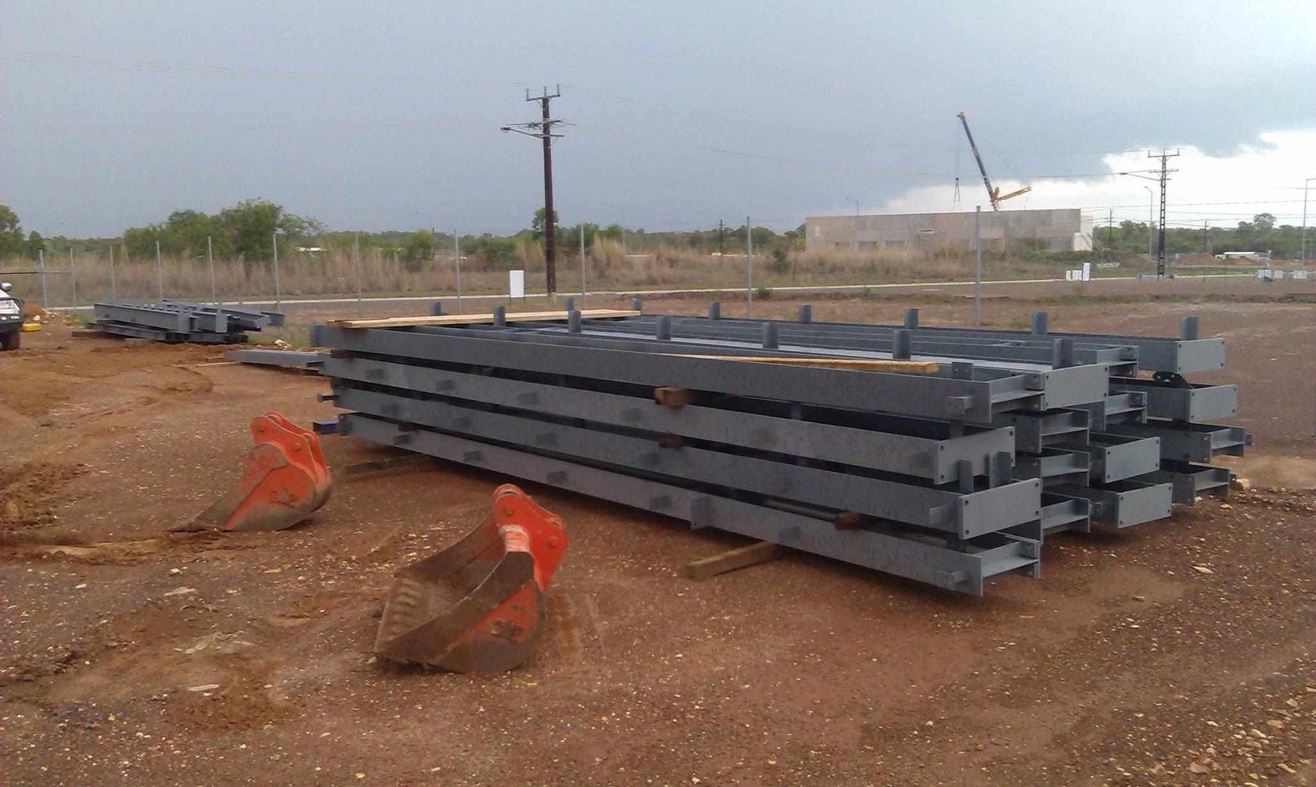 A Stack of Metal Pieces in a Dirt Field — Roll Press NT In Alice Springs, NT