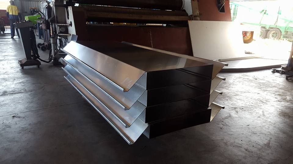 A Bunch of Metal Pieces Are Stacked on Top of Each Other — Roll Press NT In Berrimah, NT