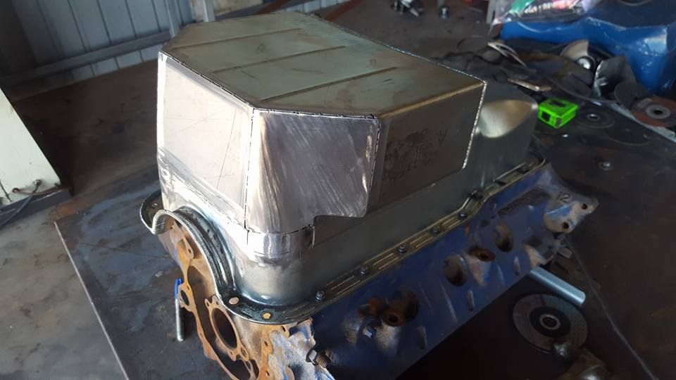 A Piece of Metal is Sitting on Top of a Car Engine — Roll Press NT In Kununurra, WA