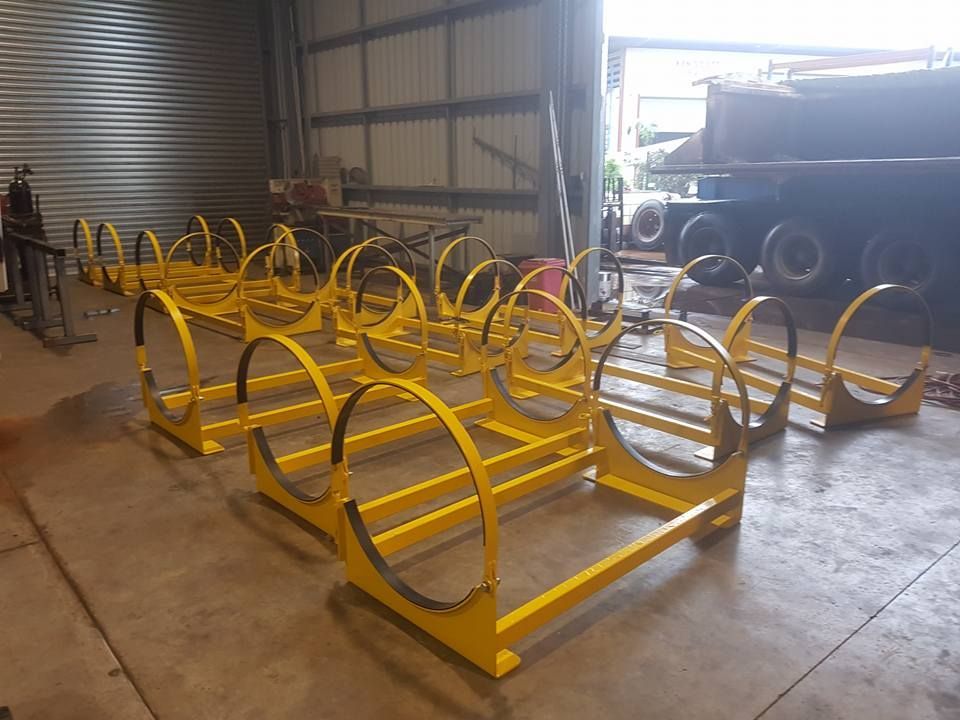 A Bunch of Yellow Metal Tubes Are Sitting on the Floor in a Warehouse — Roll Press NT In Tivendale, NT