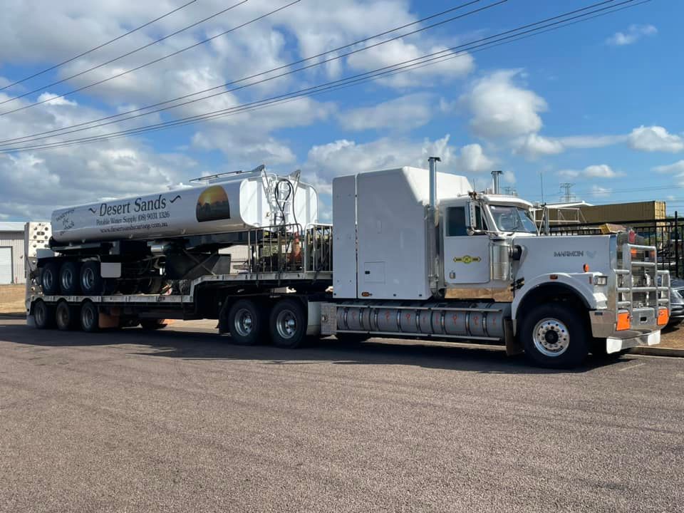 A Semi Truck With a Trailer Attached to It is Parked in a Parking Lot — Roll Press NT In Tivendale, NT