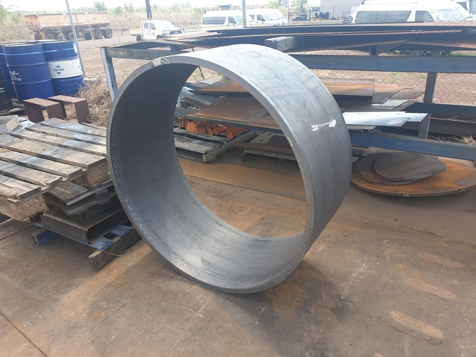 A Large Metal Ring is Sitting on Top of a Wooden Pallet — Roll Press NT In Tivendale, NT