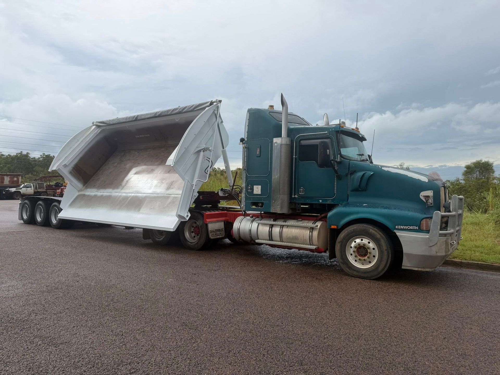 A Side Tipper Truck On The Side Of The Road