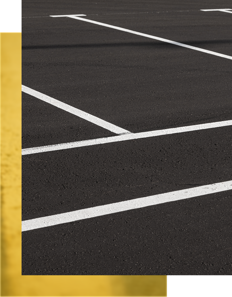 Parking lot with white lines on black asphalt.
