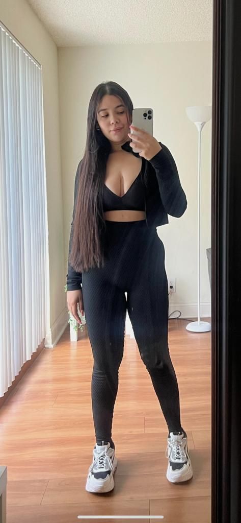 A woman is taking a selfie in front of a mirror.