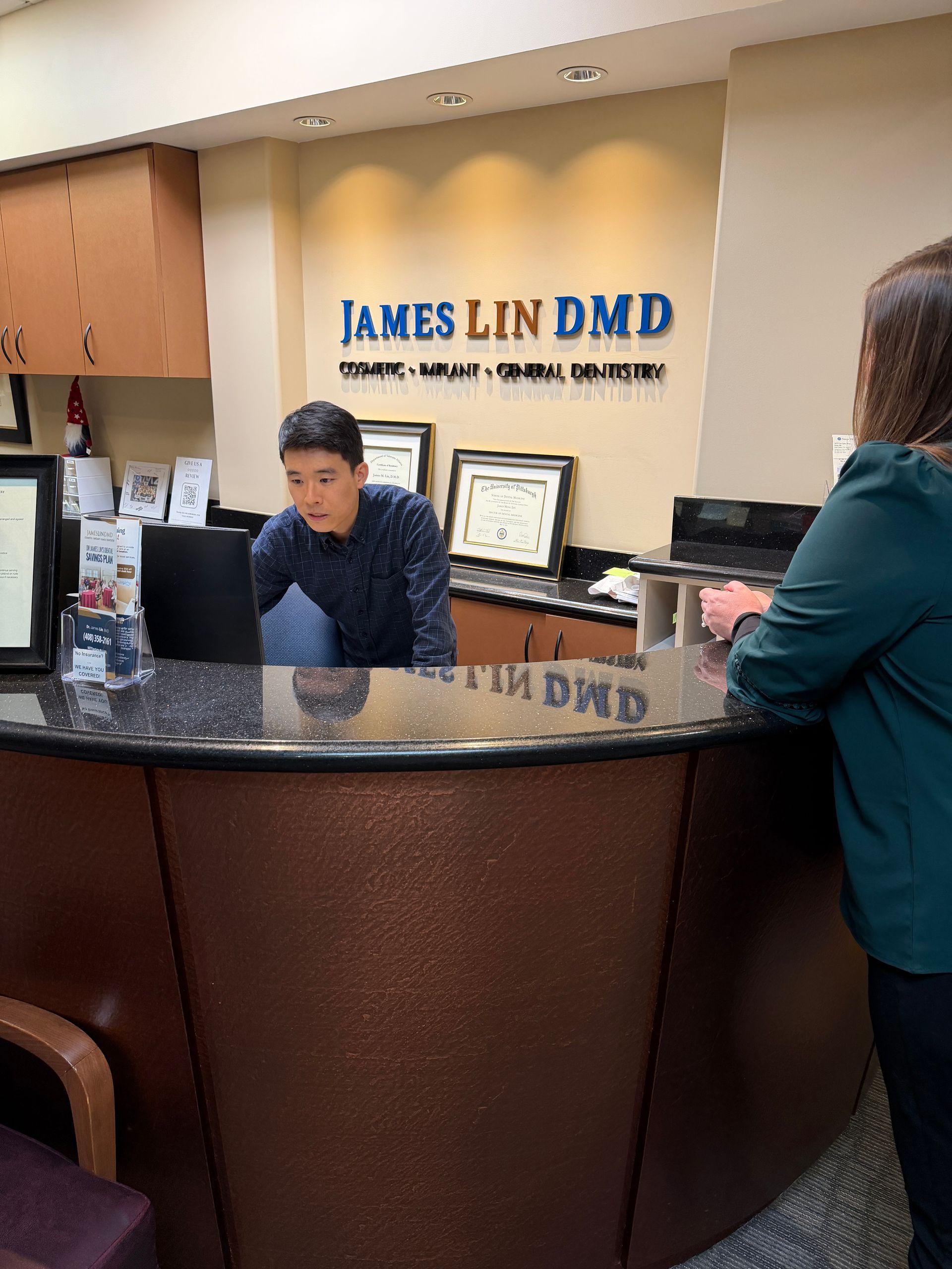Woman using a dental scanner with a mouth retractor in a dental clinic