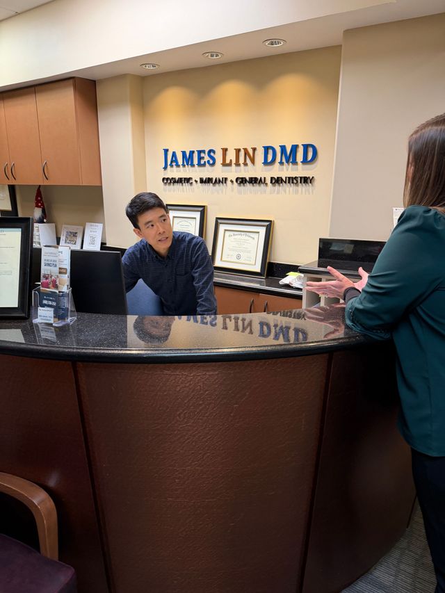 Smiling man shakes hands in a bright office lobby