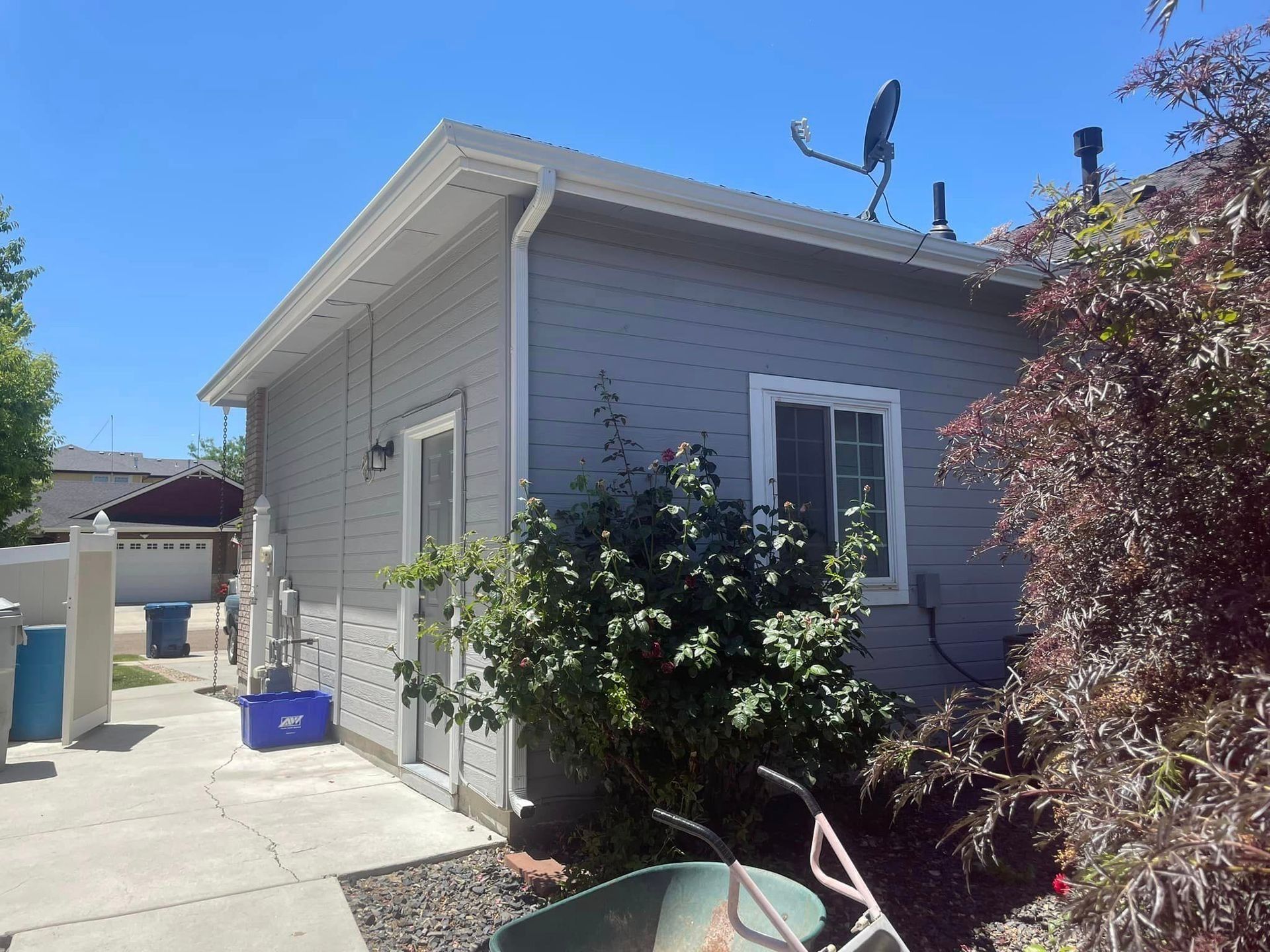 A small house with a newly installed roof gutter