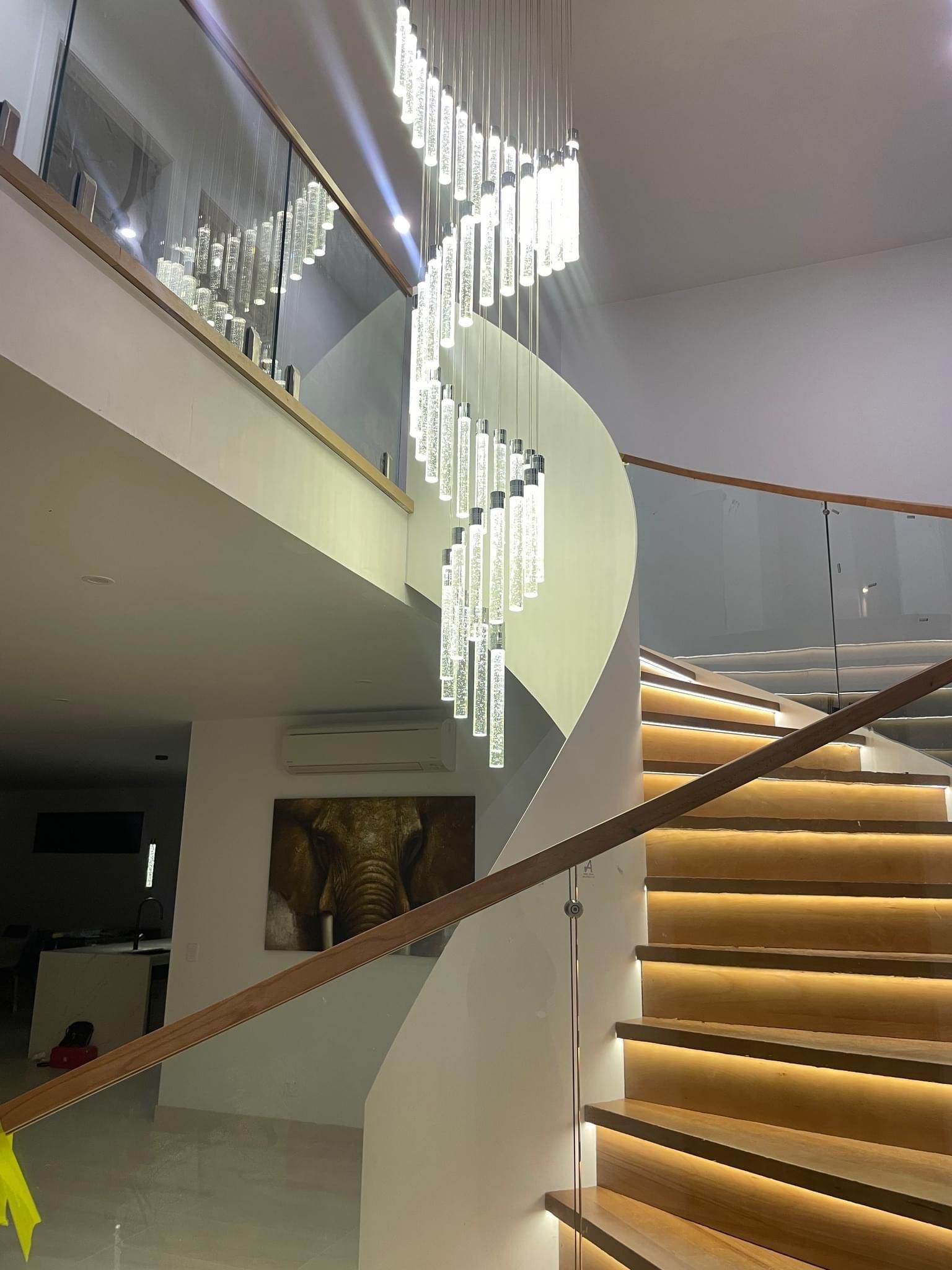Spiral Staircase With a Modern Chandelier and Wood Accents — CDT Electrical in Lennox Head, NSW