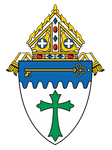 A shield with a green cross and a key on it