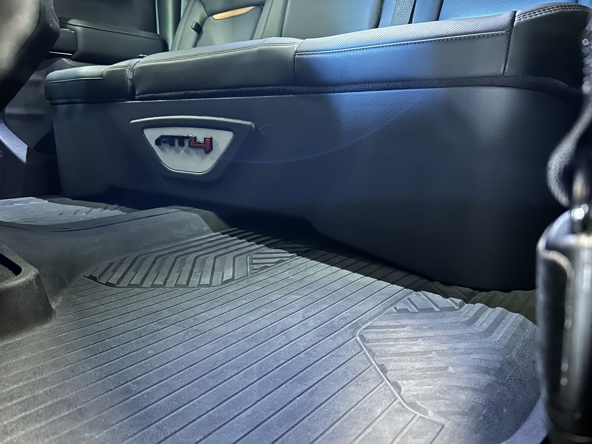 The back seat of a car has a box that says atv on it
