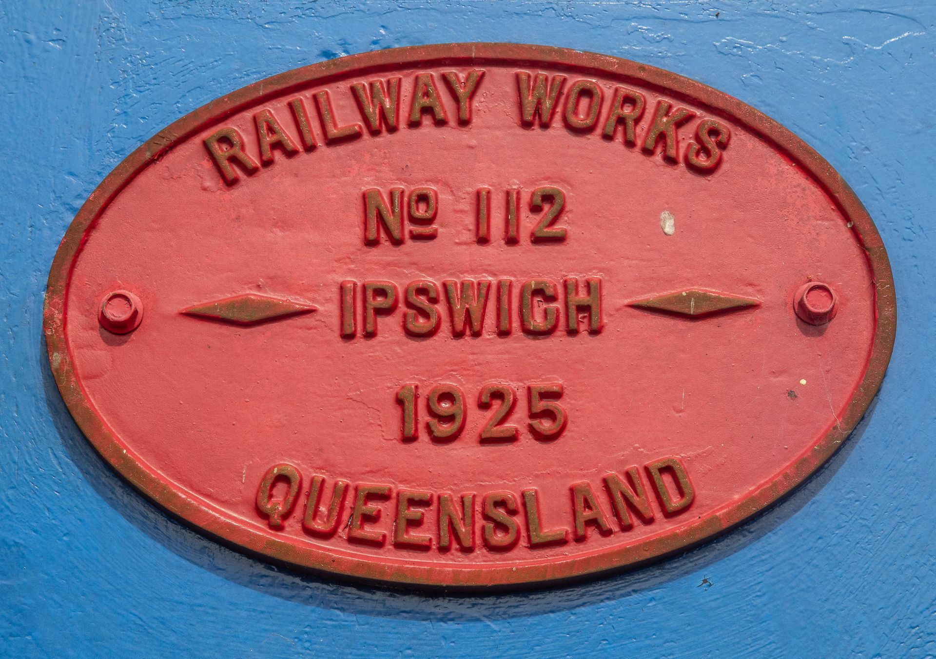 Red oval sign from Railway Works Ipswich, Queensland, with 