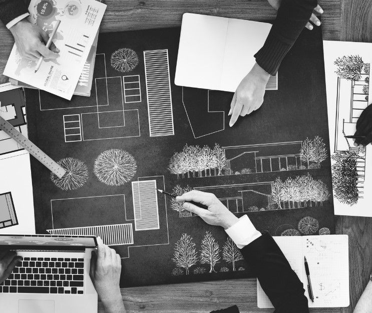 A black and white photo of a group of people working on a project