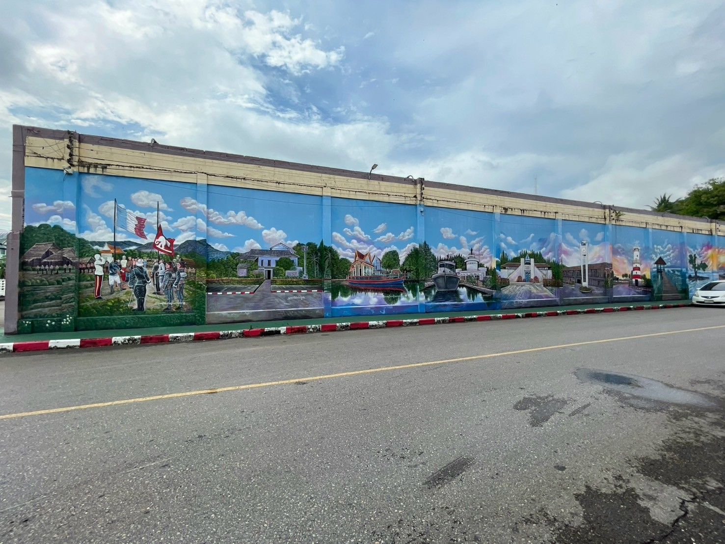 There is a large mural on the side of a building.