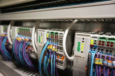 Close-up of a network server cabinet with colorful cables and patch panels.