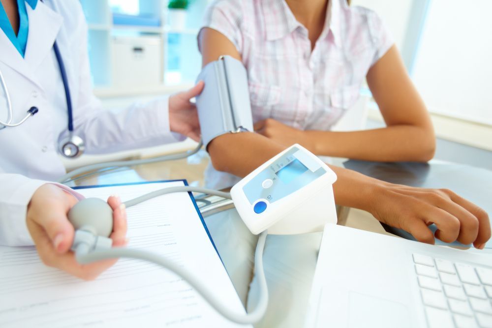 Taking blood pressure — Twin Peaks Finance In Helensvale, QLD