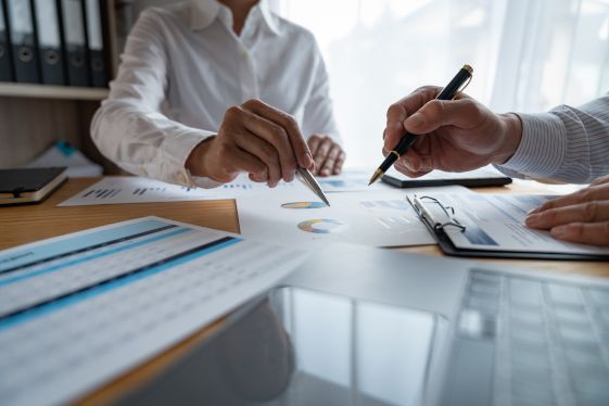 A Man and A Woman Are Sitting at A Table Looking at Papers — Twin Peaks Finance In Helensvale, QLD