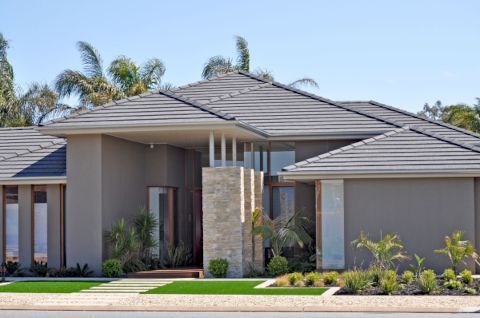 Young couple holding keys in front of a house— Twin Peaks Finance In Helensvale, QLD