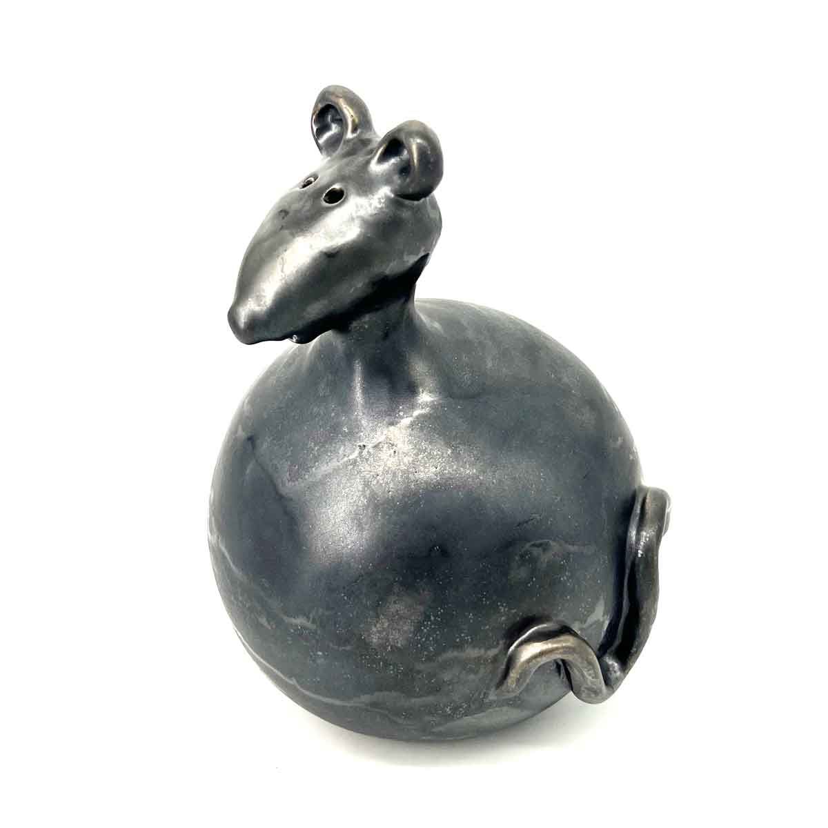 Klein grijs keramisch kikkerfiguurtje met uitpuilende ogen en een rond lijfje op een witte achtergrond.