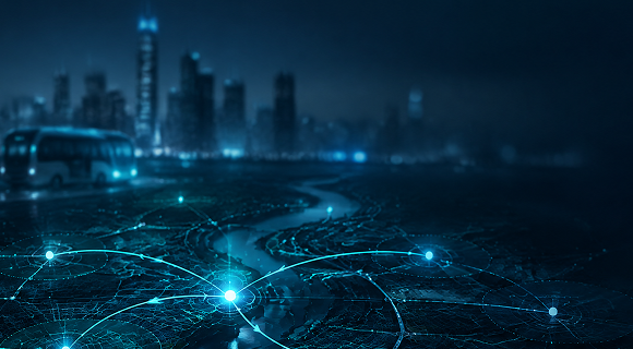Glowing blue network lines over a dark city skyline at night