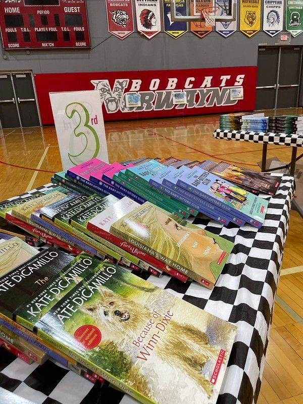 Books displayed on a checkered table with a 