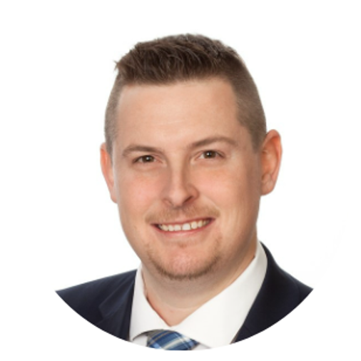 Man in a suit smiles, head and shoulders, set against a white background.