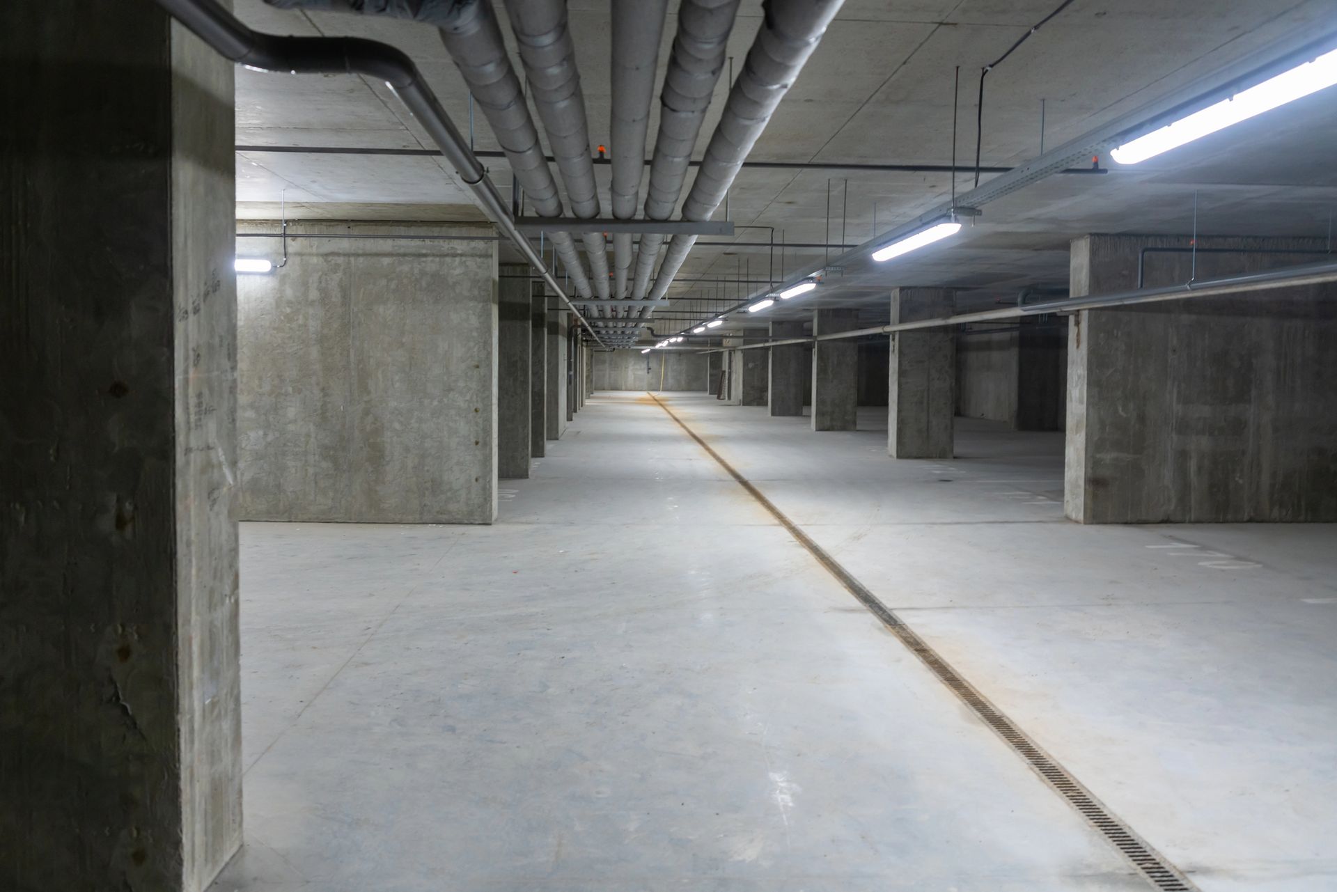 Concrete commercial basement with pipelines.