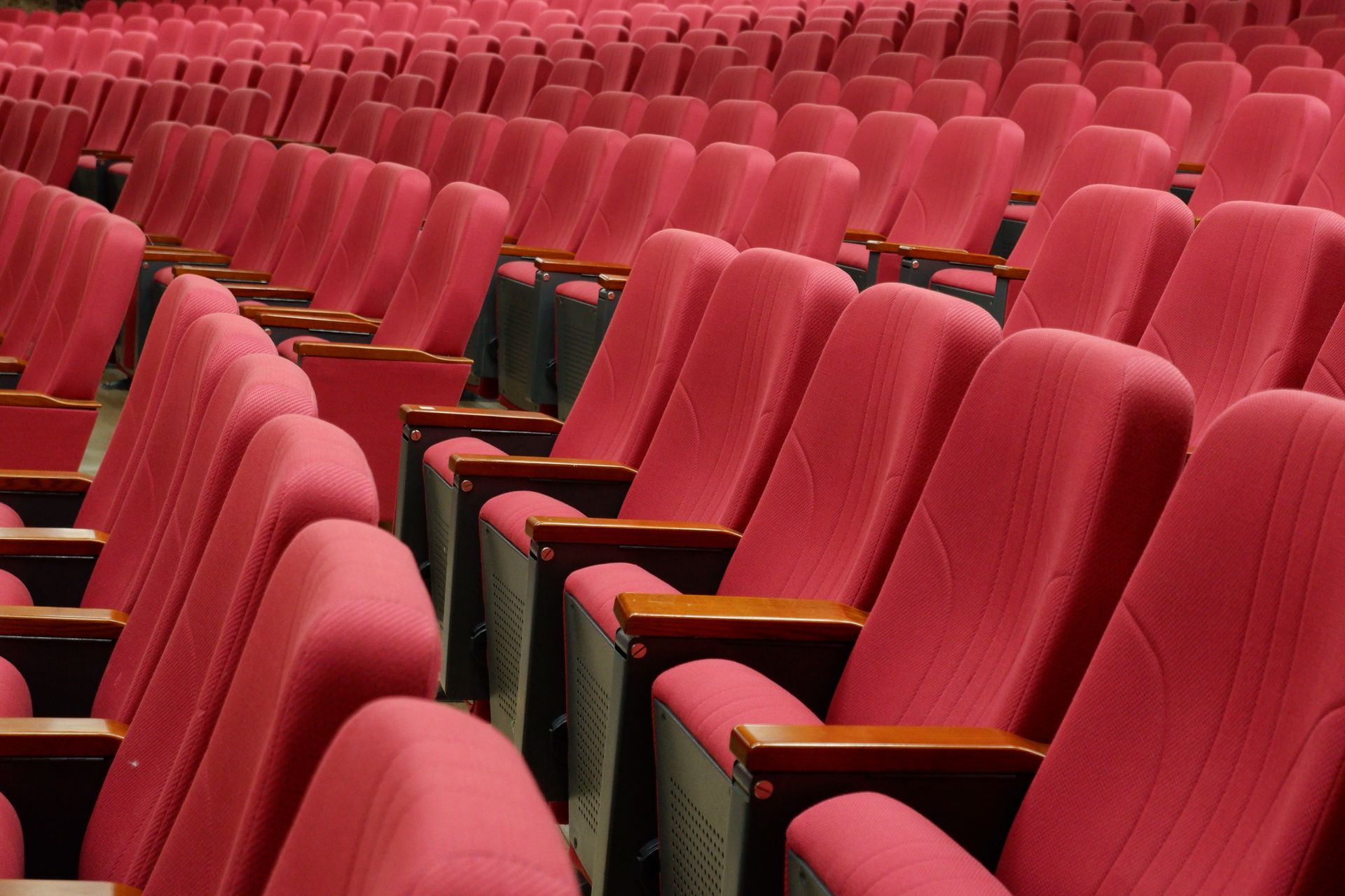 Rows of empty red theater seats.