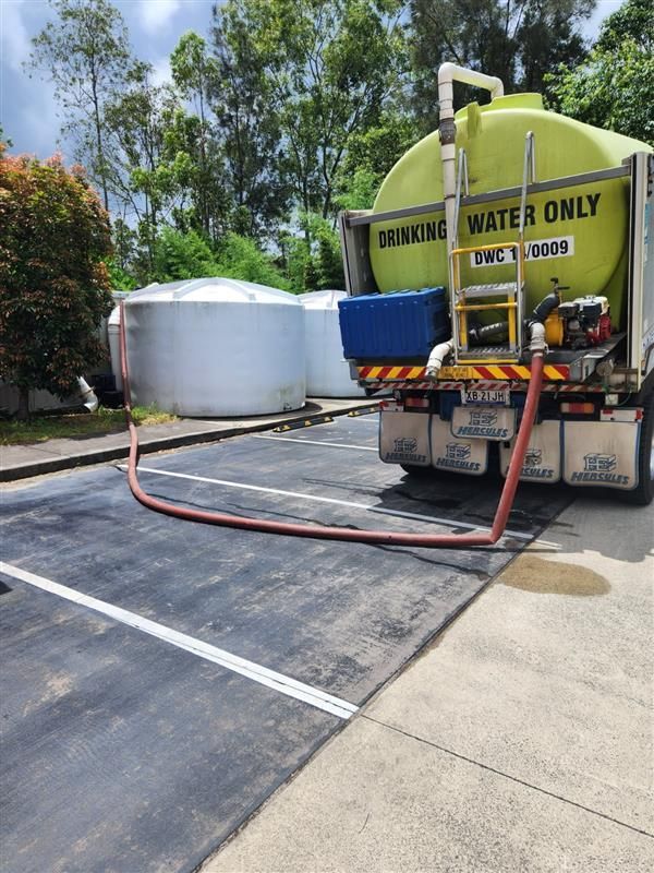 Pipe Running Water Into Water Tank — Hinterland Water Cartage in Mooloolah Valley, QLD