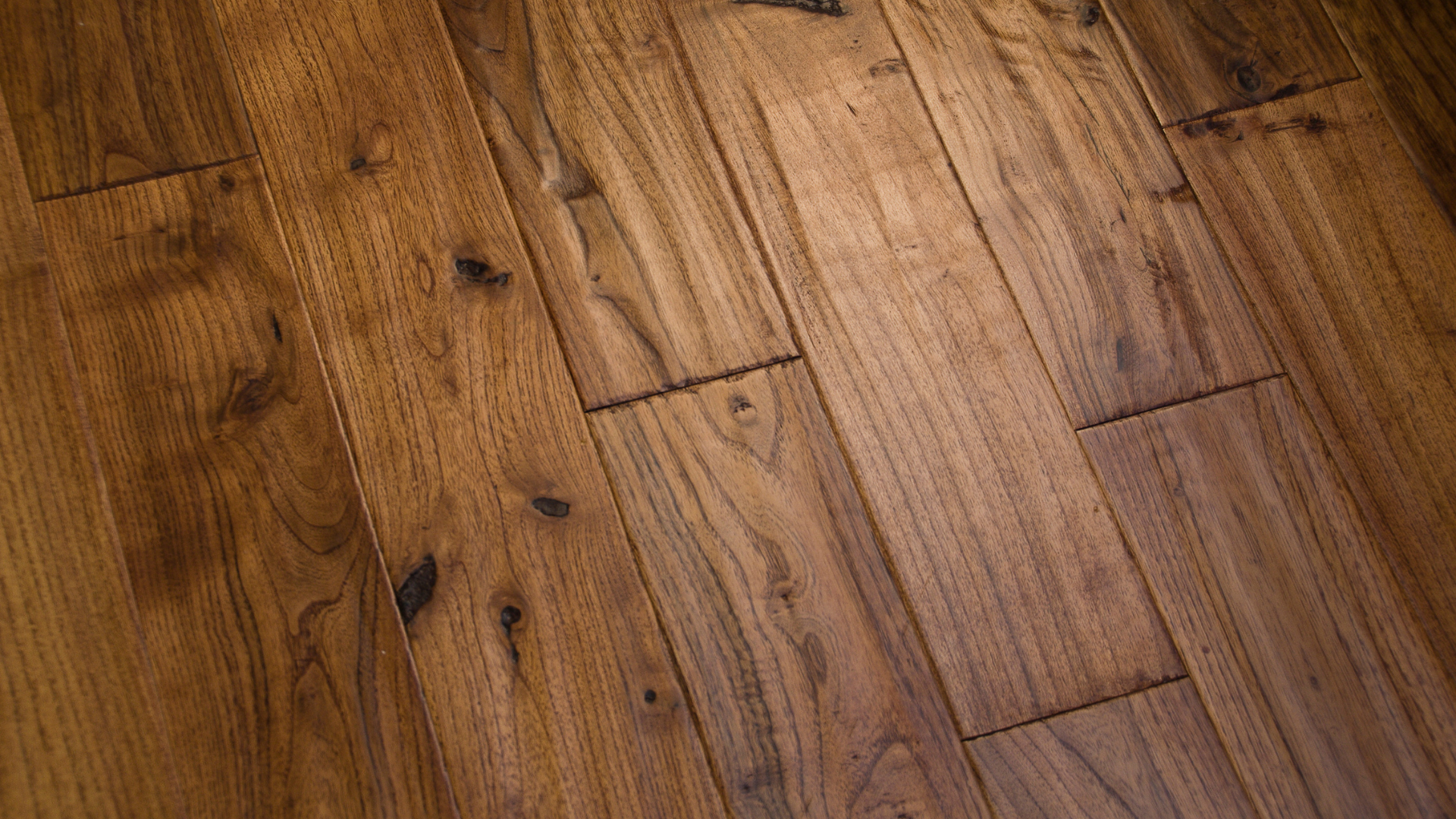A close up of a wooden floor in a room.