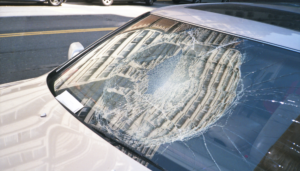 Car windshield with a large, circular crack.