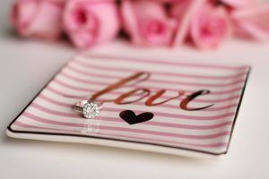 Diamond ring on a pink striped dish with 