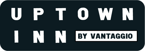 The logo for uptown inn by vantaggio is black and white