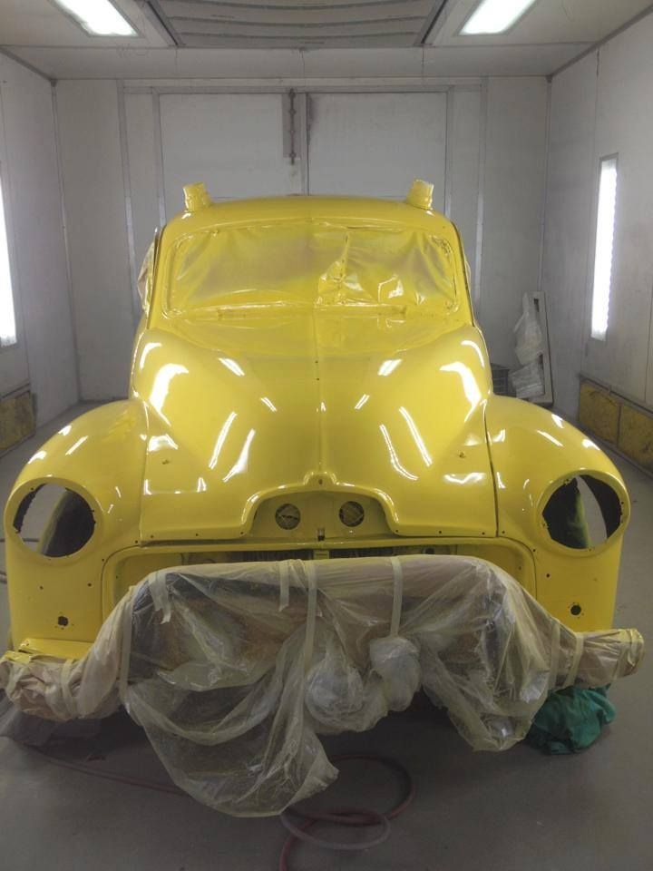 A Yellow Car Is Being Painted In A Paint Booth — All Port Smash Repairs in Port Macquarie, NSW