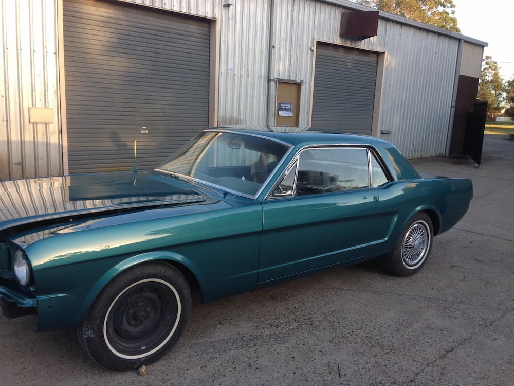 A Green Mustang Is Parked In Front Of A Garage — All Port Smash Repairs in Kempsey, NSW