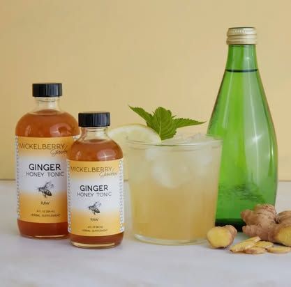 Bottles of ginger honey tonic and a mixed drink with fresh ginger and mint. Level Up Falcon