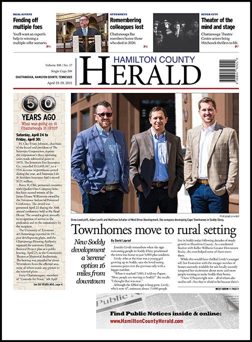 The front page of the hamilton county herald newspaper shows three men standing next to each other.