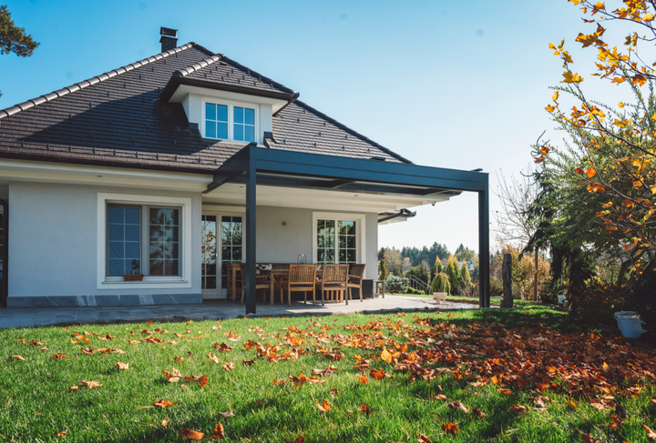 Black standing seam metal roof in Belleville. The roof has solar panels installed on it.