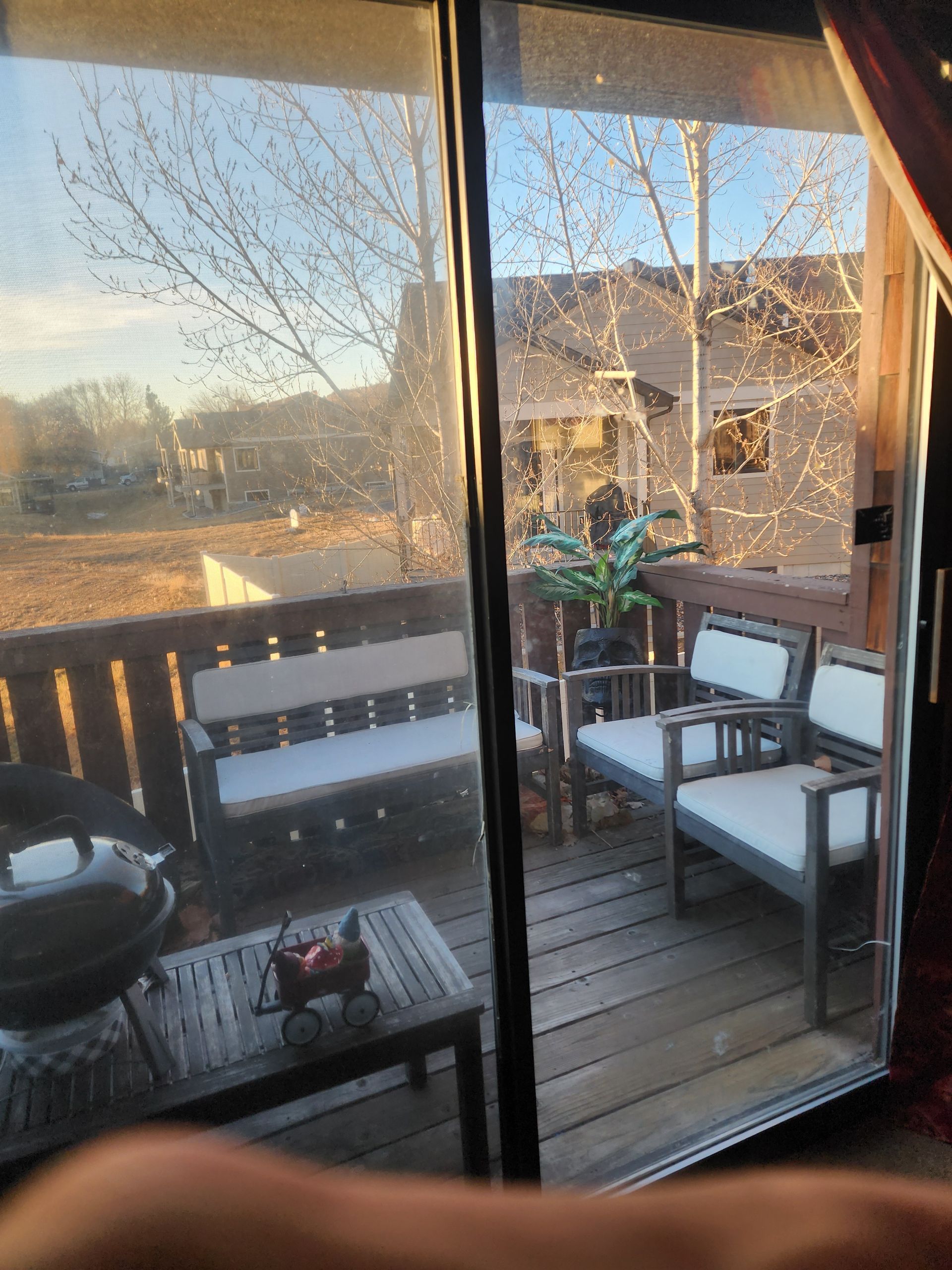 A view of a deck through a sliding glass door