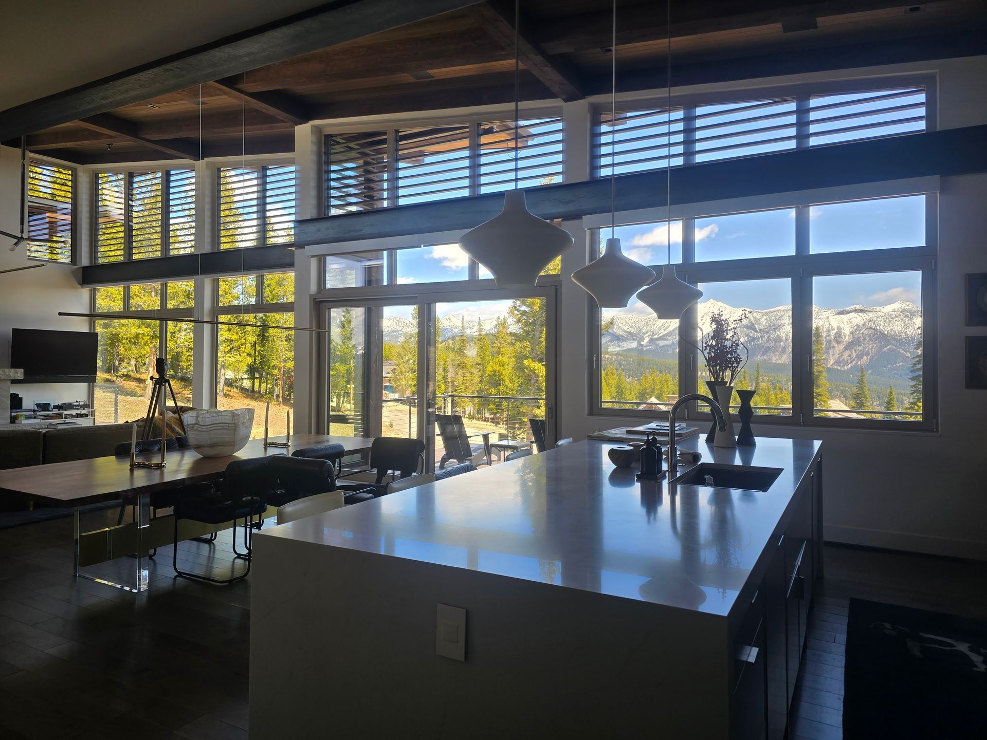 A kitchen with a large island and a lot of windows.