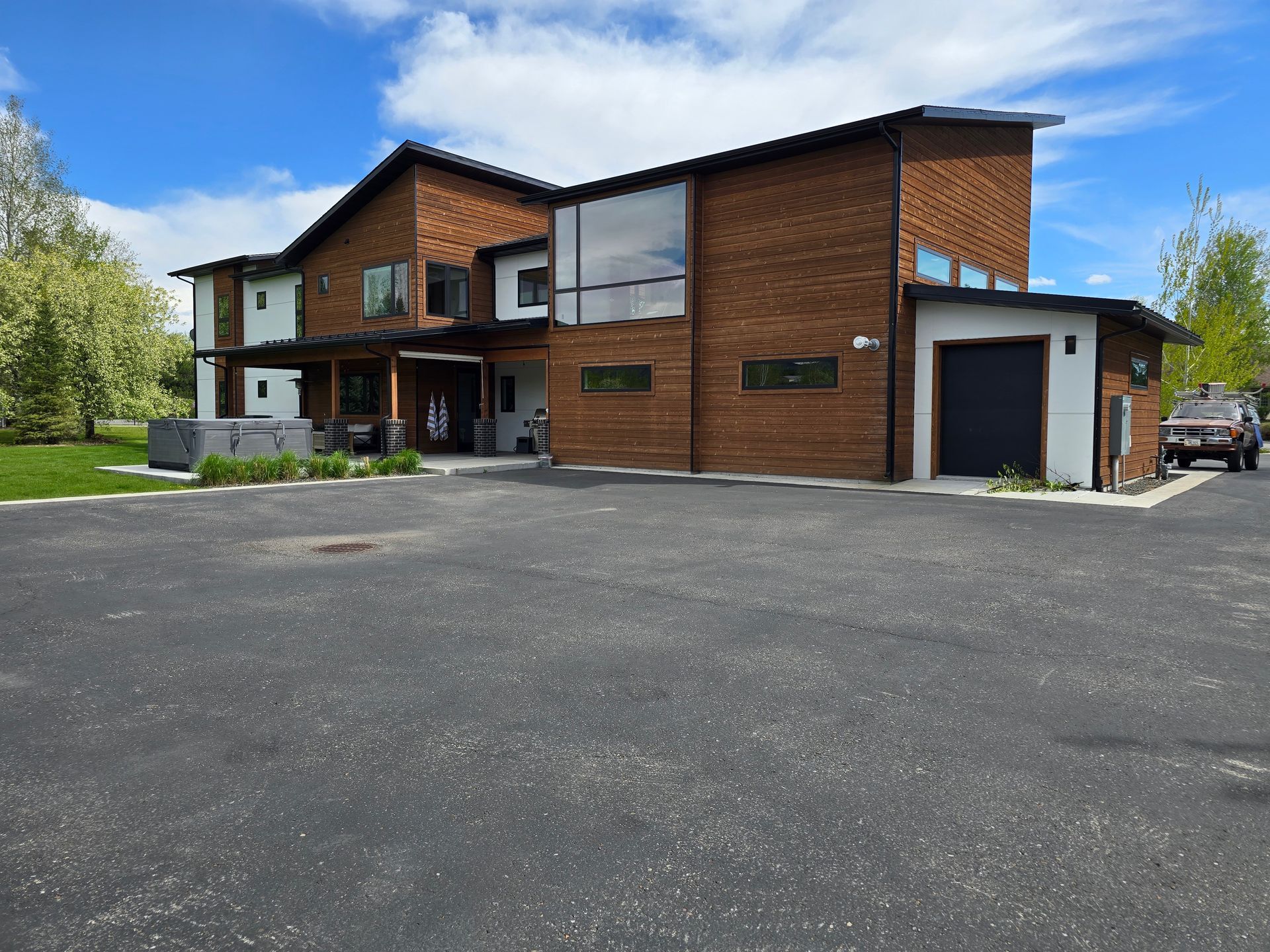 A large house with a lot of windows and a car parked in front of it