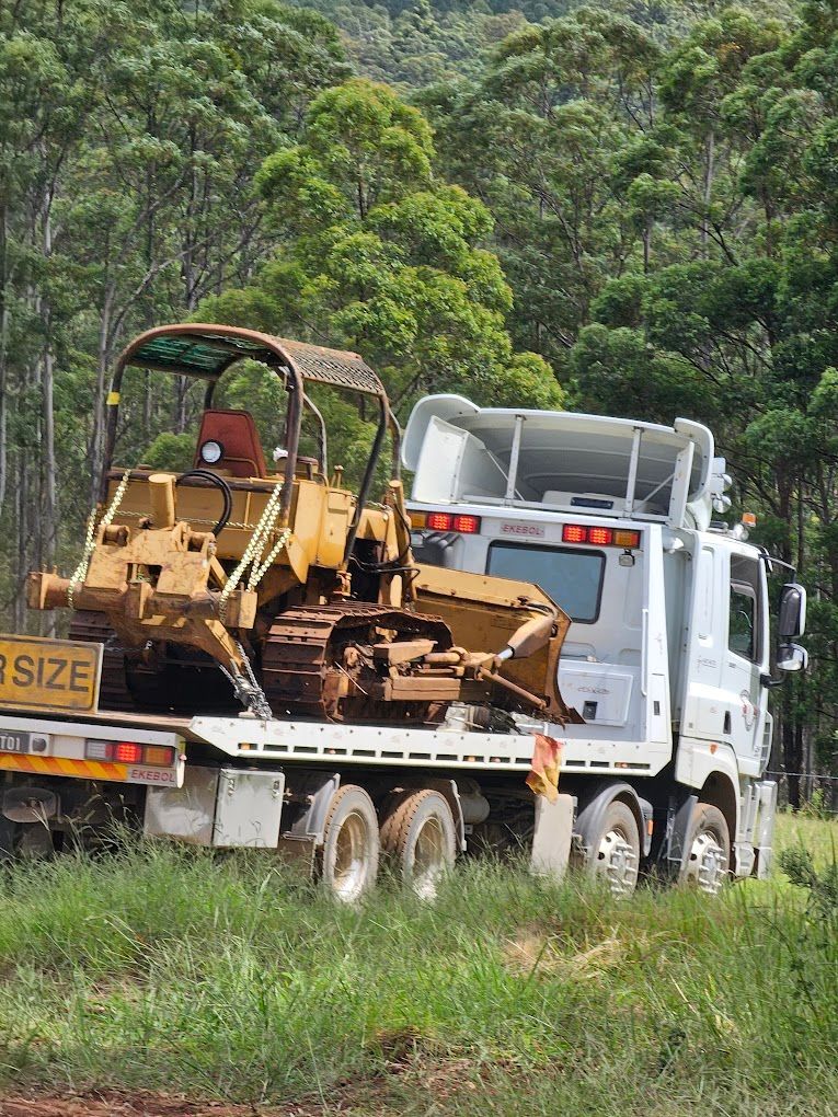 A Blue Semi Truck Is Driving Down A Highway — RJN Transport In Tamworth, NSW
