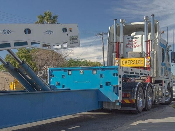 An Oversize Truck Is Driving Down The Road — RJN Transport In Glen Innes, NSW