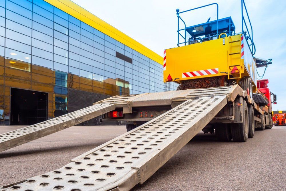 A Truck With A Crane On The Back Of It Is Parked In Front Of A Building — RJN Transport In Inverell, NSW