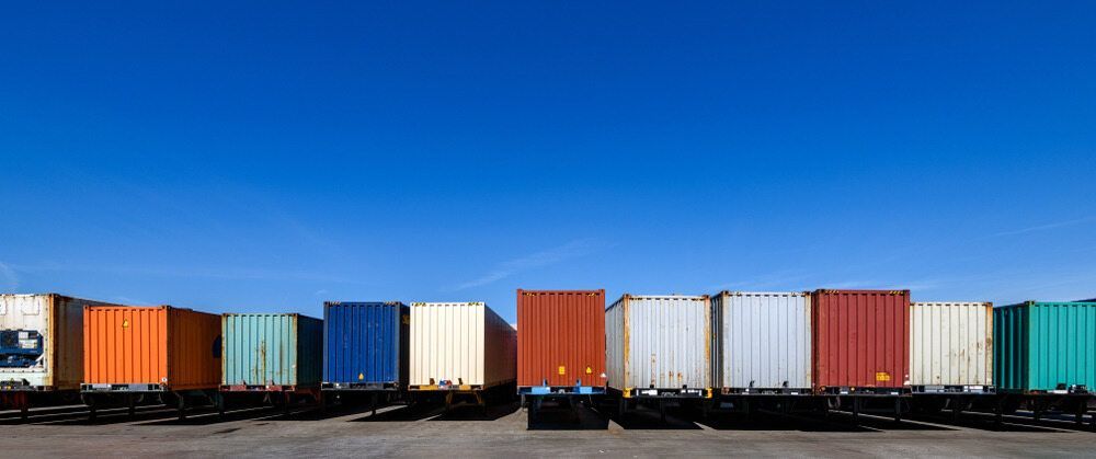 A Row Of Shipping Containers Are Lined Up In A Parking Lot — RJN Transport In Coonabarabran, NSW