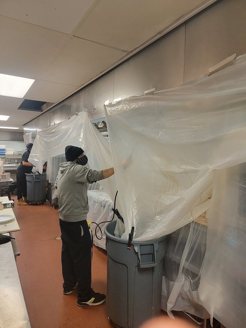 Worker Cleaning The Kitchen — Springfield, MA — Advanced Air Quality, Inc.