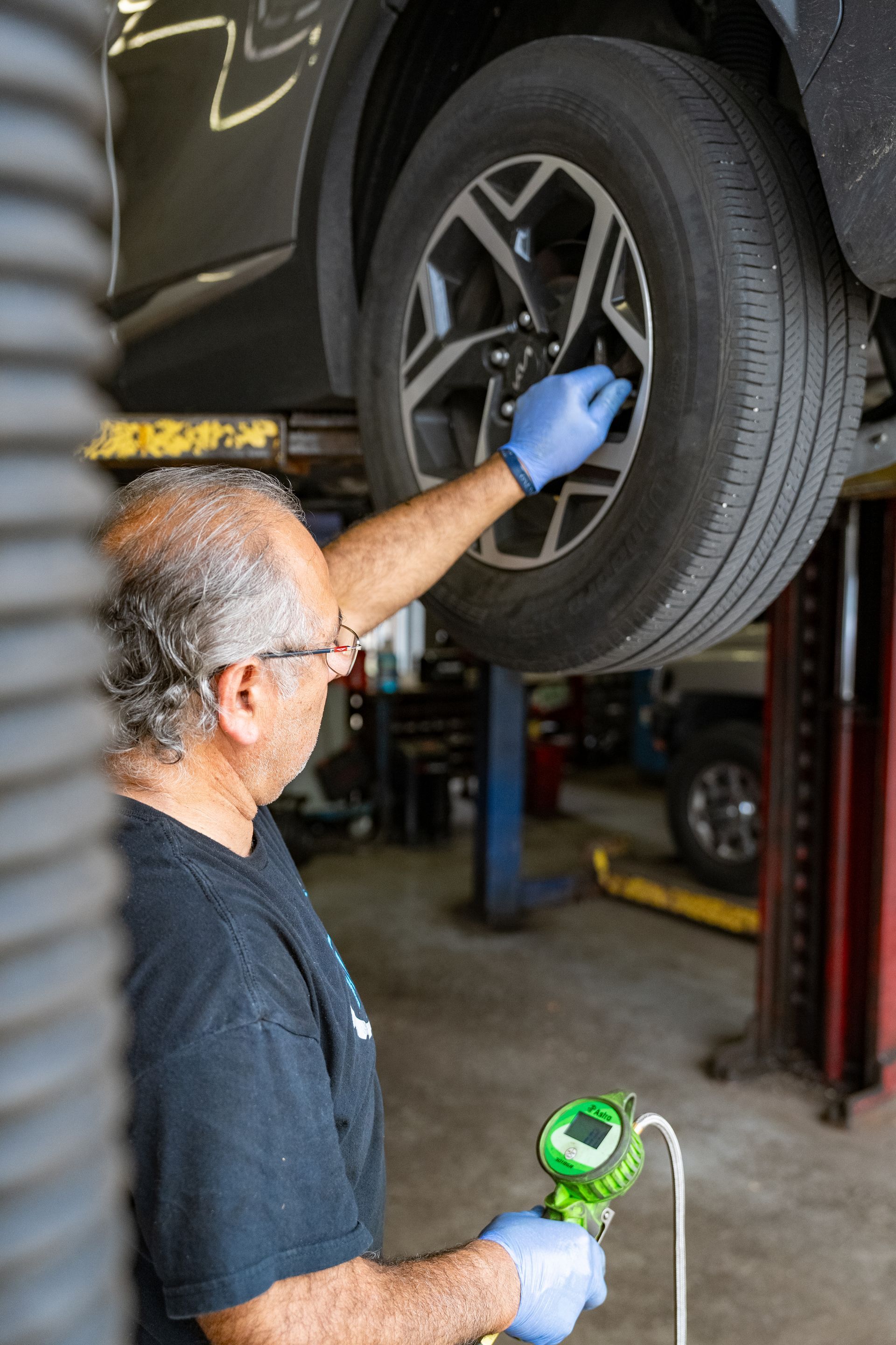 Inspecting. tire at Westchester at Hi-Tech Auto Specialists in IL