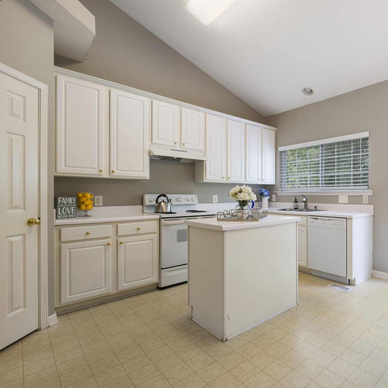 Photo of a kitchen with white cabinetry.