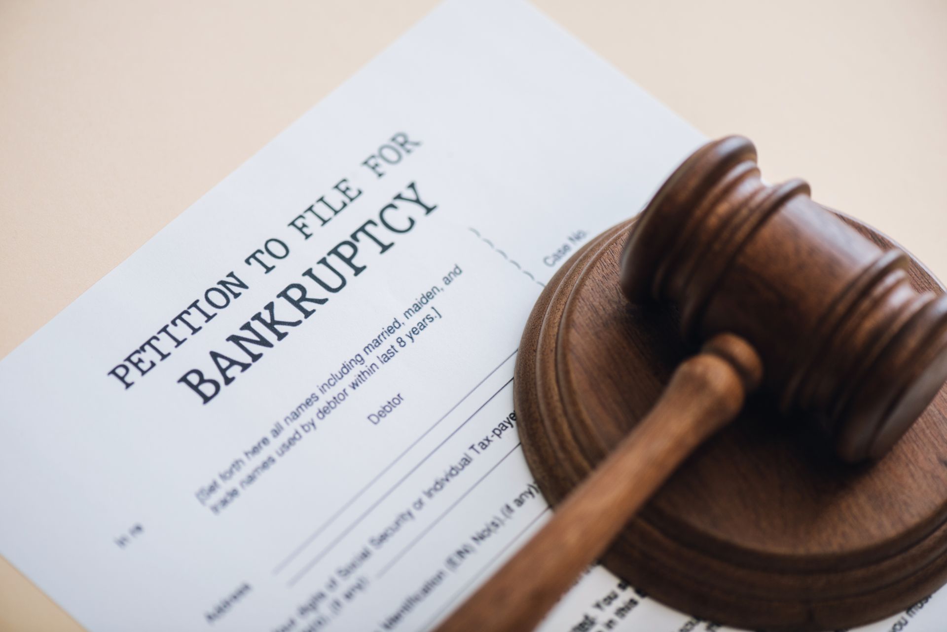 A petition to file for bankruptcy sits next to a judge's gavel.
